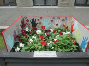 2014 Festival of Flowers planter box with artwork by students at The Migrants Centre.